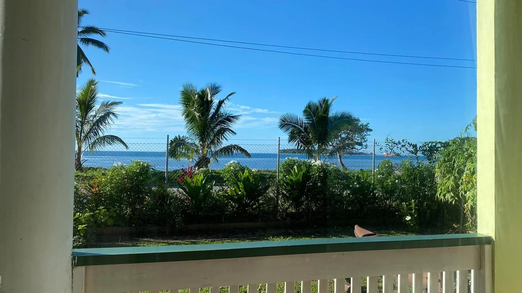 View of the garden and ocean from a ground-floor apartment