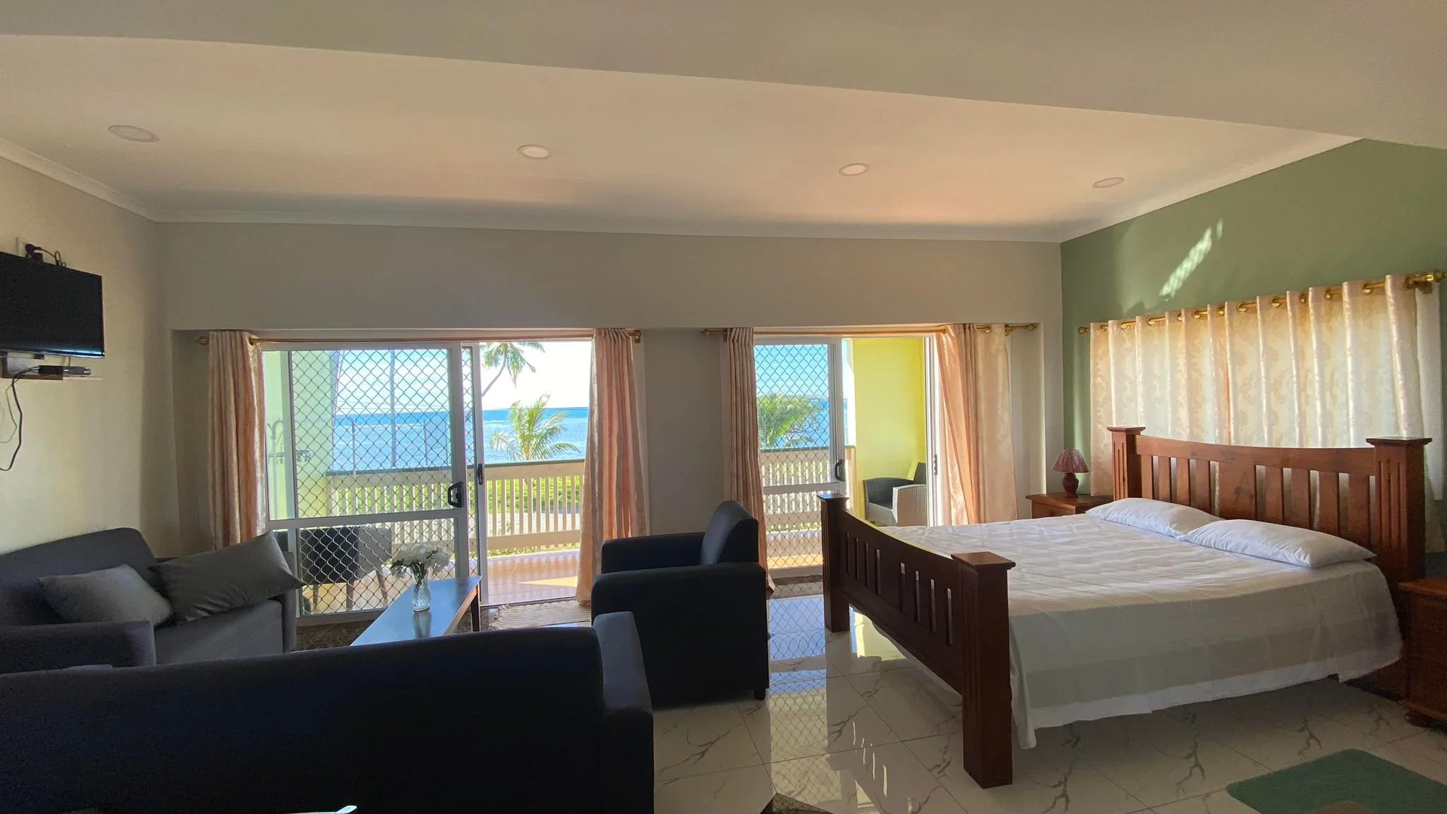 Open Plan 01 Inside lounge area, with view onto balcony and South Pacific Ocean in the background.