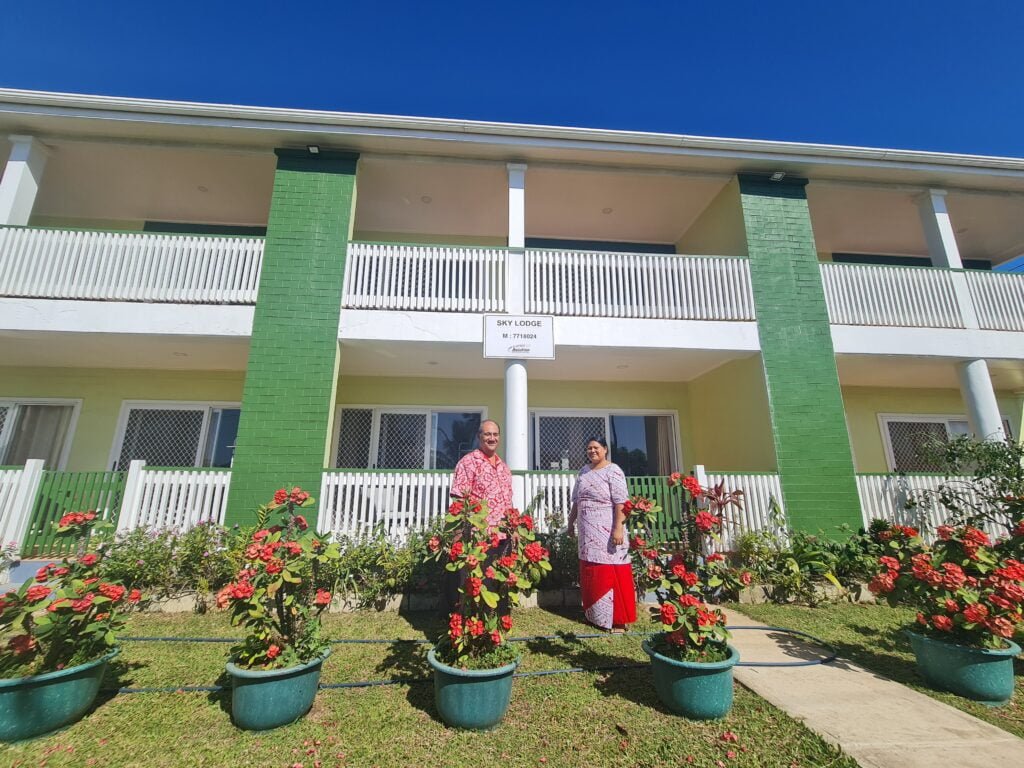 Sky lodge staff in front of building