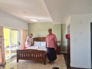 People posing next to bed