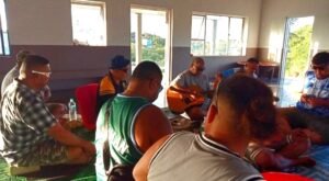 Men sitting down drinking kava 