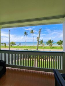 balcony view of beachfront with tress